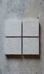 a wall with four blocks of different white colors on it