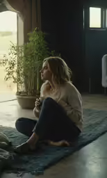 a woman sitting on the ground eating food