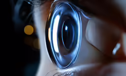 a person with some kind of magnifying glass to look into