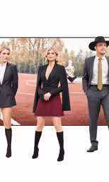 the woman in red is posing with other people