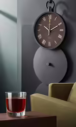 a glass and a clock on a gray wall