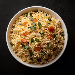 a bowl with noodles, tomatos and green leaves in it