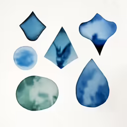 a paper with several different colored shapes and one that has a blue leaf on it