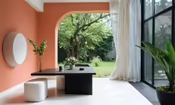 an outdoor room with a table and two stools
