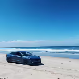 a black sports car parked at the edge of an empty beach