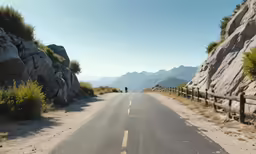 person on motorcycle riding in the middle of an open road