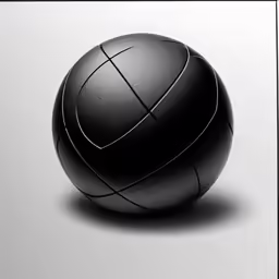 a black ball sitting on top of a white surface