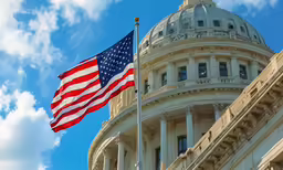 a flag flies in front of the capitol building