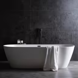 a bath tub with towels on it near an open window