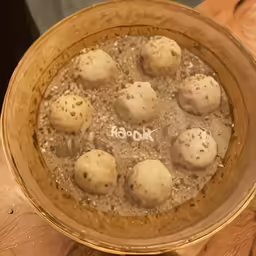 a bowl full of dumplings and brown broth