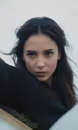 a girl is looking back with serious looks on her face