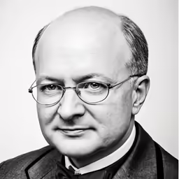 a black and white portrait of a well - dressed man with a bow tie