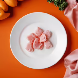 a plate with raw meat on top of it