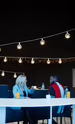 a couple are sitting at a table eating together