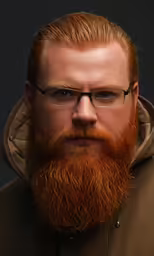 a man with a red beard, wearing glasses