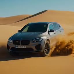 the bmw x4 driving down a desert track