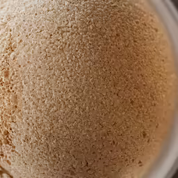 close up shot of a cake with white icing on it