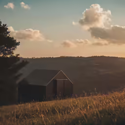 a small cabin that sits in the middle of a field