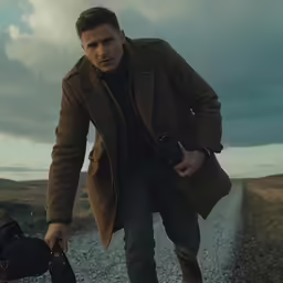 a man with a bag is walking down the road