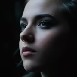 a close up of a woman in profile with eyes wide open