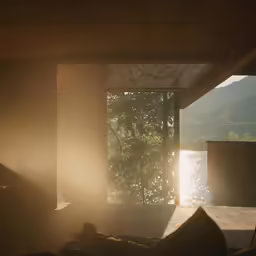 the sun shines brightly through the glass window onto a body of water