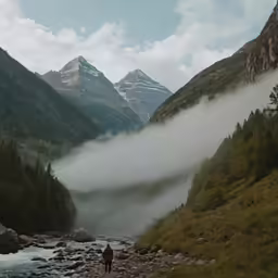 a man on a rocky stream crossing a river
