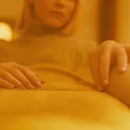 a woman in white holding onto her finger and touching it