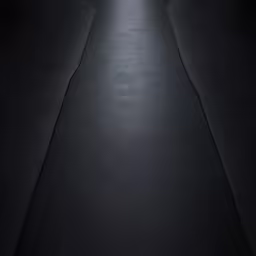 a man wearing blue stands on the runway of a runway