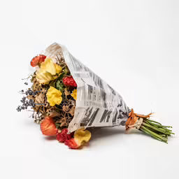this is a bouquet of flowers wrapped in newspaper