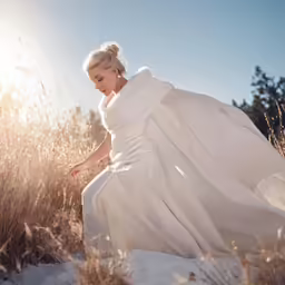 a woman with a white dress and long cloak