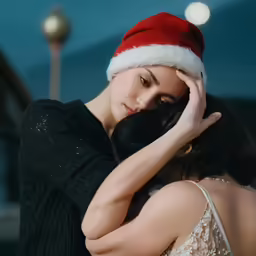 woman with a santa hat standing near her