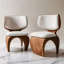 a pair of white chairs sitting next to each other