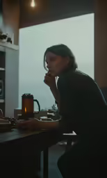 a girl is holding a cup and looking at the side