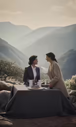 two women at a table talking on the hillside