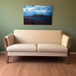 a picture hanging on the wall above a couch
