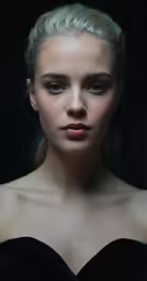 a woman wearing black with long blonde hair