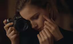 a woman holding her camera up to the camera