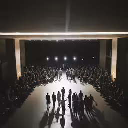 a man and woman are standing together at the end of a runway