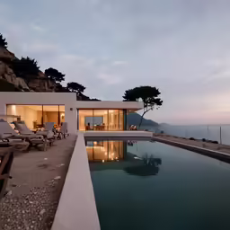 the large pool is near a beach with lounge chairs