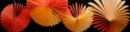 four red, orange and yellow folded fan shapes