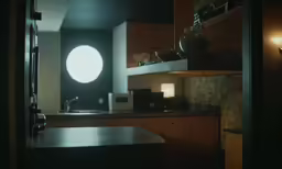 a dark kitchen with wooden cabinets and counters