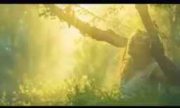 the woman is in a wooded area taking pictures