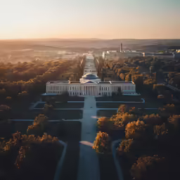 a large white building that has a lot of trees