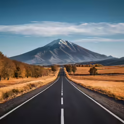 two straight empty roads next to an area of flat land