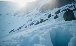 the sun shining down on a hill full of snow