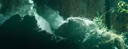 a group of people in the dark are laying