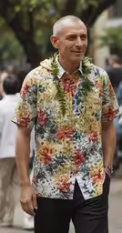 man in hawaiian shirt walking down the street