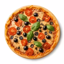 a pizza on a plate with tomatoes, olives and basil
