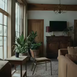 a living room with two chairs and a tv