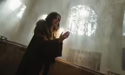a person that is standing in front of a window